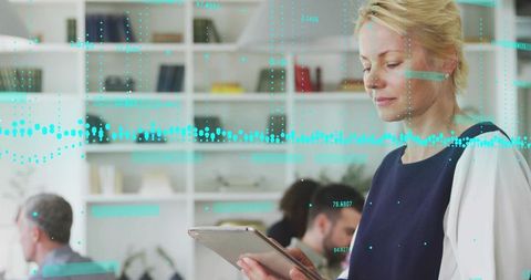 Professional Woman Analyzing Data on Digital Tablet in Modern Office