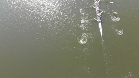 Overhead View of Women's Rowing Team Racing on River
