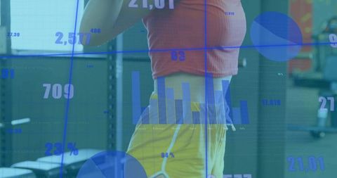 Female Athlete Analyzing Workout Data in High-Tech Gym Environment
