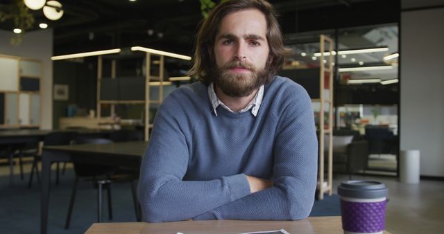 Serious Man Sitting at Desk with Coffee in Modern Office - Download Free Stock Images Pikwizard.com