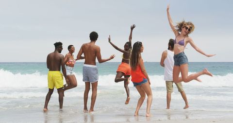 Diverse Friends Celebrating at Ocean Shoreline