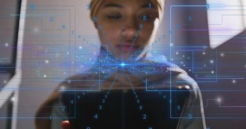 Woman using smartphone wearing headwrap with blue augmented reality overlay in dim corridor