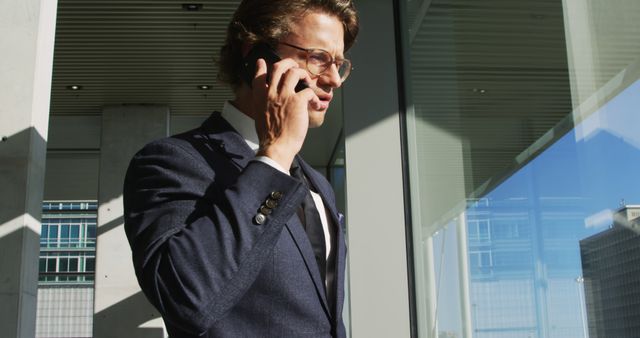 Businessman Talking on Smartphone Outside Modern Office Building - Download Free Stock Images Pikwizard.com