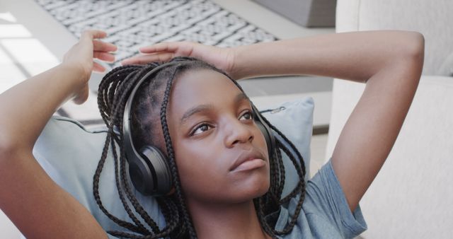 Young African American Girl Relaxing at Home with Headphones - Download Free Stock Images Pikwizard.com