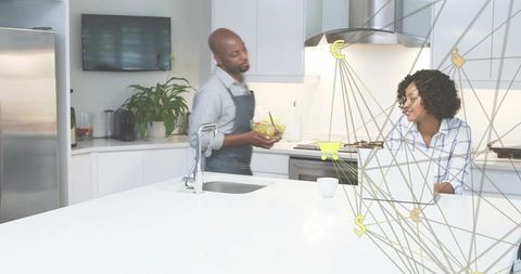 Couple embracing modern technology at home kitchen