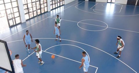 African American Men Playing Basketball on Indoor Court