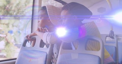 Two Women Reflecting While Traveling by Bus, Light Bokeh Effect
