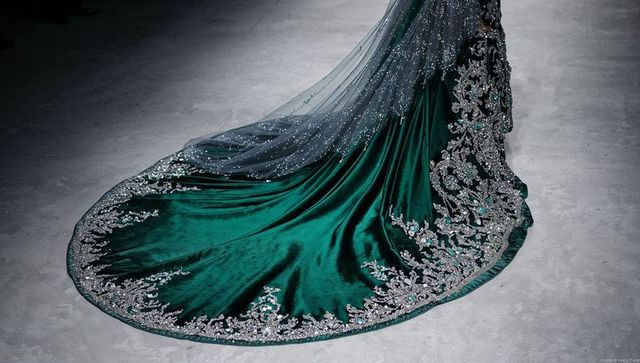 Cascading emerald velvet gown train with intricate silver embroidery and beaded veil