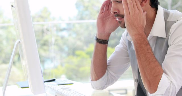 Stressed Businessman Working at Office Desk with Computer - Download Free Stock Images Pikwizard.com