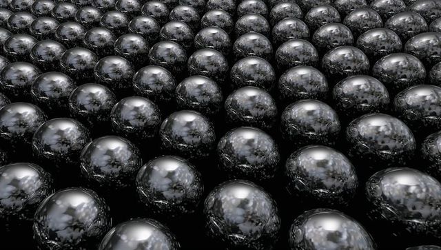 Shimmering reflective black spheres forming tessellated grid reflecting sky and trees