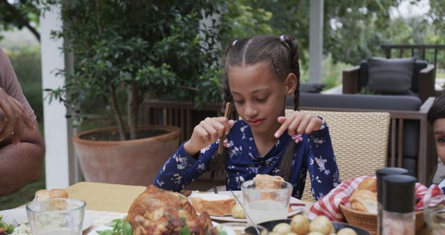 Family Dining Together Outdoors with Child in Focus - Download Free Stock Images Pikwizard.com