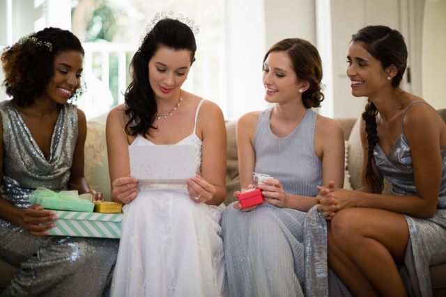 Bride receiving gifts from bridesmaids at home