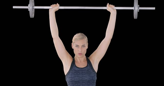 Strong Woman Lifting Barbell Overhead Against Black Background - Download Free Stock Images Pikwizard.com