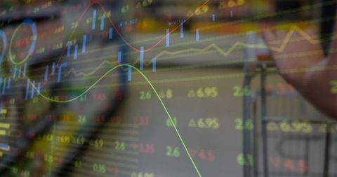 Transparent candlestick market overlay on office screen showing realtime trading analytics