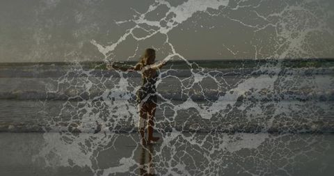 Woman standing arms outstretched at beach shoreline with abstract sea foam texture overlay