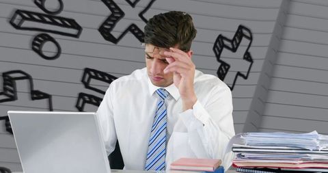 Businessman Focusing on Work with Laptop and Papers