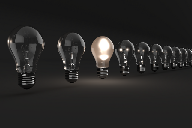 Row of Transparent Light Bulbs with One Lit Against Black Background - Download Free Stock Videos Pikwizard.com