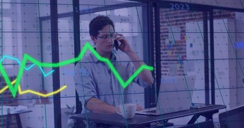 Businessman Strategizing with Financial Graphs in Modern Office