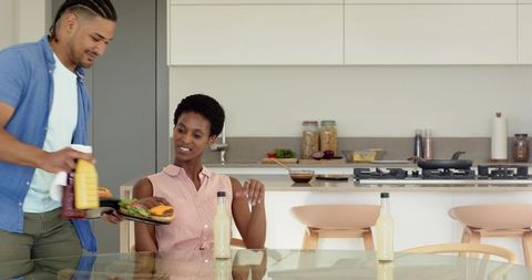 Diverse Couple Enjoying Breakfast in Modern Kitchen