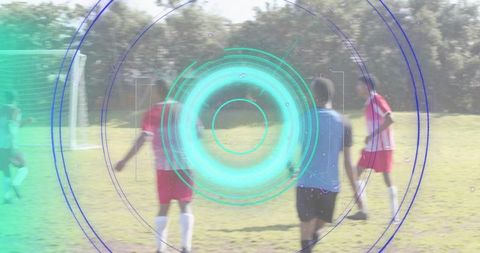 Men playing soccer wearing red-white kits with futuristic HUD overlay on sunny grass pitch