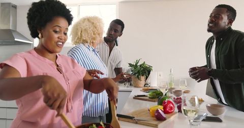 Friends Socializing in Modern Kitchen While Cooking Together