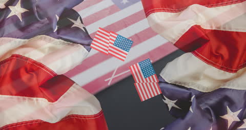 Patriotic Display of American Flags Flowing Over Closeup Background