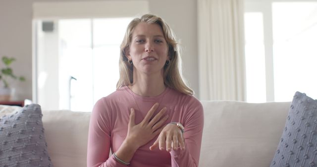 Woman with Blonde Hair Speaking and Gesturing on Couch - Download Free Stock Images Pikwizard.com