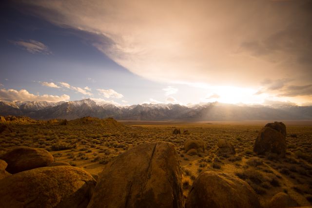Sunsetting Over Rocky Desert Landscape with Mountain Range in Background - Download Free Stock Photos Pikwizard.com
