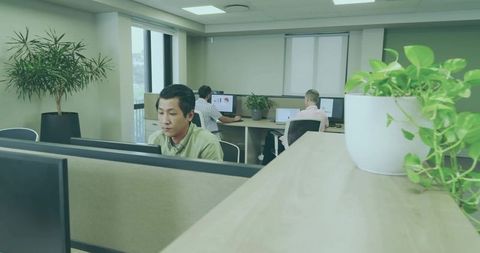 Diverse office team focused on productivity amidst greenery