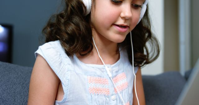 Young Girl Enthralled in Educational Audio on Headphones Indoors - Download Free Stock Images Pikwizard.com