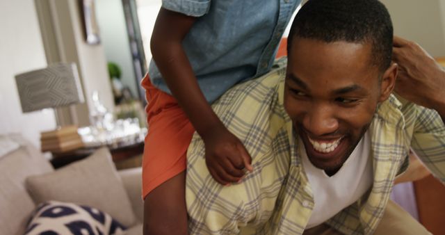 African American Father Playing with Child in Living Room - Download Free Stock Images Pikwizard.com