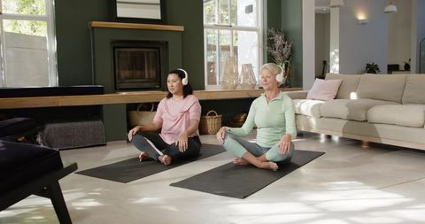 Senior Friends Meditating Together in Contemporary Home Setting