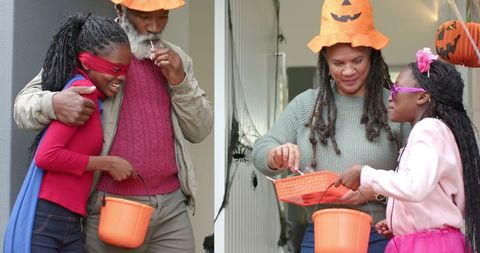 Multigenerational family handing out candy to children at halloween doorway wearing pumpkin hats