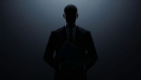 Mysterious executive silhouette standing in halo backlight holding portfolio and documents