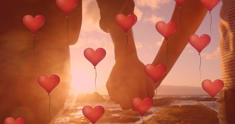 Romantic Couple Holding Hands at Sunset with Hearts