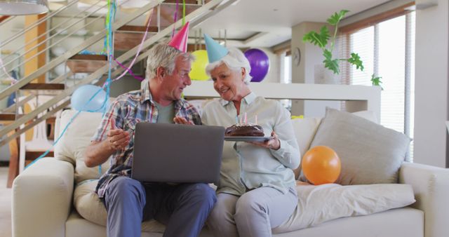 Happy Senior Couple Celebrating Birthday with Cake and Laptop - Download Free Stock Images Pikwizard.com