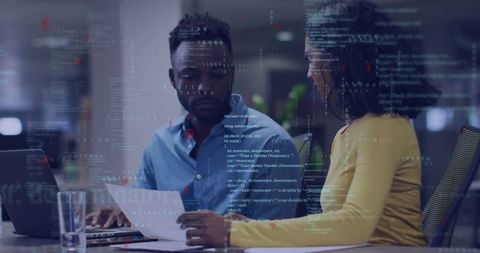 Business Professionals Collaborating Over Documents in Modern Workspace