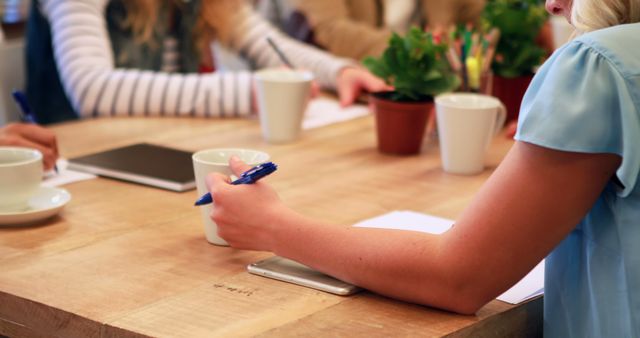 Casual Business Meeting with Tea and Plants in Background - Download Free Stock Images Pikwizard.com