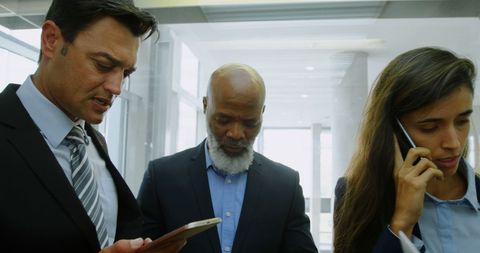 Diverse Business Professionals Engaging with Technology in Office