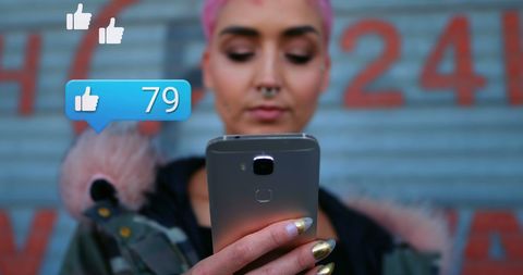 Young Woman Receiving Social Media Likes on Her Phone