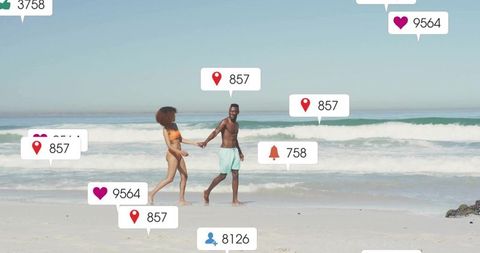 Couple Enjoying Beach Stroll with Social Media Engagement