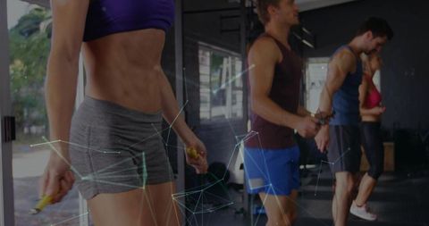 Jumping rope group training featuring fit woman in purple sports bra and gray shorts