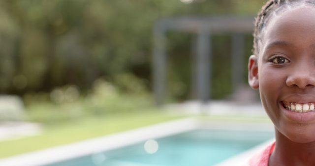 Smiling girl outdoors by swimming pool on sunny day - Download Free Stock Images Pikwizard.com