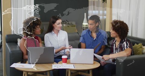 Business Team Discussing Global Strategy with Digital Overlay Graphics