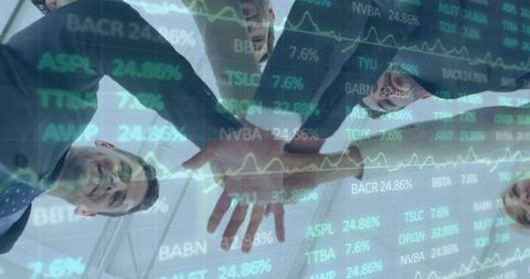 Corporate team joining hands beneath glass atrium with financial stock tickers and data overlays