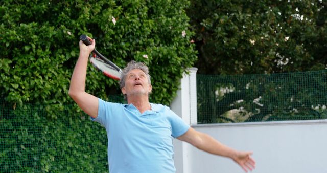 Senior Man Playing Tennis Outdoors Taking a Swing - Download Free Stock Images Pikwizard.com