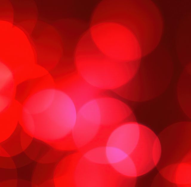 This abstract red bokeh background features soft circles of light, creating a dreamy and vibrant effect. It is ideal for use in festive designs, holiday greeting cards, advertisements, website backgrounds, and decorative art pieces. The gentle glow adds a touch of elegance and warmth to any project.