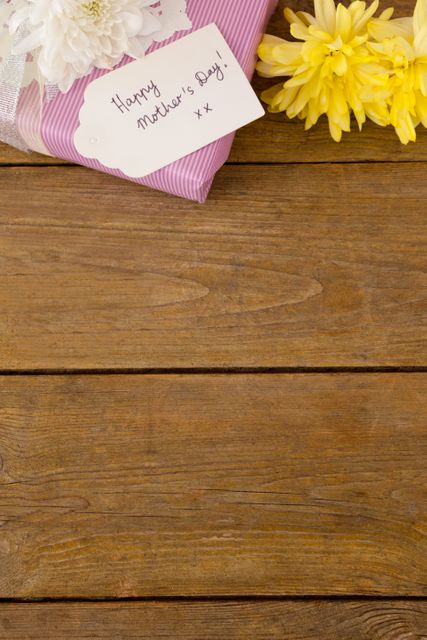 Mother's Day Gift with Flowers and Card on Wooden Table - Download Free Stock Photos Pikwizard.com