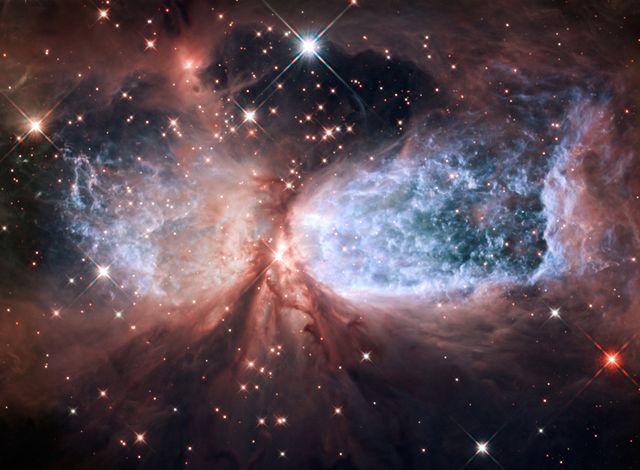 This celestial image showcases the bipolar star-forming region known as Sharpless 2-106, resembling a snow angel with twin lobes of glowing super-hot gas. Perfect for use in educational materials, space-related blogs, and astronomical research presentations, it highlights the beauty and complexity of star formation. The image, captured by the Hubble Space Telescope, vividly demonstrates the dynamic processes in space and adds an inspiring visual element to any astronomy-themed project.
