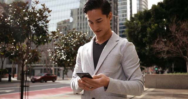 Young Professional Checking Smartphone in Urban Setting - Download Free Stock Images Pikwizard.com